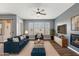 Well-lit living area with hardwood floors, fireplace, ceiling fan, and large windows with plantation shutters at 19475 N Grayhawk Dr # 2151, Scottsdale, AZ 85255
