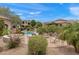 Community pool with lounge chairs surrounded by lush landscaping and residential buildings at 19475 N Grayhawk Dr # 2151, Scottsdale, AZ 85255