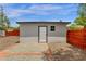 Close up of a detached garage featuring gravel and brick trim, surrounded by a wooden fence at 2122 W Virginia Ave, Phoenix, AZ 85009