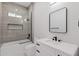 Bathroom featuring a tub, shower and a white vanity with a square mirror at 2122 W Virginia Ave, Phoenix, AZ 85009