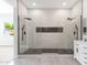 Modern bathroom showcasing a glass shower with dual shower heads, sleek tile and elegant fixtures at 2122 W Virginia Ave, Phoenix, AZ 85009