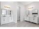 Elegant bathroom featuring dual vanities with marble countertops and modern light fixtures at 2122 W Virginia Ave, Phoenix, AZ 85009