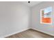 Bright bedroom with wood flooring, white walls and a window with neighborhood views at 2122 W Virginia Ave, Phoenix, AZ 85009