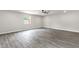 Bright, open bedroom featuring modern wood laminate flooring, a ceiling fan and a window at 2122 W Virginia Ave, Phoenix, AZ 85009