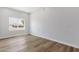 Bedroom with a window, wood flooring, white walls, and baseboards at 2122 W Virginia Ave, Phoenix, AZ 85009
