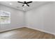 Bedroom with a ceiling fan and large window providing ample natural light at 2122 W Virginia Ave, Phoenix, AZ 85009