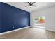 Bright bedroom with wood flooring and sliding doors to the backyard patio at 2122 W Virginia Ave, Phoenix, AZ 85009