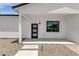 Stylish front entrance with modern door, adjacent window, and minimalistic landscaping, enhancing curb appeal at 2122 W Virginia Ave, Phoenix, AZ 85009