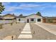 Charming single-story home featuring a modern exterior with a well-maintained gravel yard and paver walkway at 2122 W Virginia Ave, Phoenix, AZ 85009