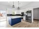 Bright kitchen featuring stainless appliances, stylish pendant lighting, and ample countertop space at 2122 W Virginia Ave, Phoenix, AZ 85009