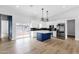 Modern kitchen featuring white cabinetry, stainless steel appliances, and a stylish blue kitchen island at 2122 W Virginia Ave, Phoenix, AZ 85009