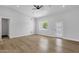 Bright living room featuring new floors, a modern ceiling fan, and a door with three glass panels at 2122 W Virginia Ave, Phoenix, AZ 85009
