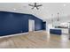 Open-concept living room featuring luxury flooring, a blue accent wall, and a kitchen with a peninsula at 2122 W Virginia Ave, Phoenix, AZ 85009