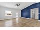 Bright and airy living room featuring new floors, a modern door, and an accent wall at 2122 W Virginia Ave, Phoenix, AZ 85009