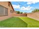 View of the backyard with turf and string lights, great for entertaining and relaxing at 21667 S 225Th Way, Queen Creek, AZ 85142