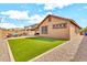 Spacious backyard features low maintenance landscaping including gravel, grass, and patio at 21667 S 225Th Way, Queen Creek, AZ 85142