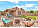 Well-kept backyard with an outdoor seating area and artificial turf at 21667 S 225Th Way, Queen Creek, AZ 85142