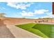 Low maintenance backyard features gravel, grass, and a patio at 21667 S 225Th Way, Queen Creek, AZ 85142