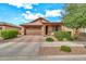 Charming single-Gathering home featuring a low maintenance front yard, two car garage, and covered porch at 21667 S 225Th Way, Queen Creek, AZ 85142