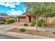 Charming single-Gathering home featuring a low maintenance front yard, two car garage, and desert landscaping at 21667 S 225Th Way, Queen Creek, AZ 85142