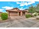 Charming single-Gathering home featuring a two car garage, covered porch with chairs, and desert landscaping at 21667 S 225Th Way, Queen Creek, AZ 85142