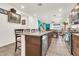 Open kitchen with granite island, dining space, and stainless steel appliances, ideal for entertaining at 21667 S 225Th Way, Queen Creek, AZ 85142