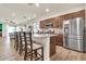 Spacious kitchen with granite countertops, stainless steel appliances, and an adjacent dining area at 21667 S 225Th Way, Queen Creek, AZ 85142