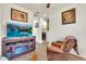 Cozy living room featuring a modern TV, comfortable chair, and inviting decor at 21667 S 225Th Way, Queen Creek, AZ 85142