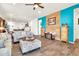 Cozy living room with wood-style flooring, modern decor, a turquoise accent wall and comfortable seating at 21667 S 225Th Way, Queen Creek, AZ 85142