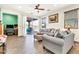 Spacious living room featuring wood-style flooring, sliding glass doors to the backyard, and lots of natural light at 21667 S 225Th Way, Queen Creek, AZ 85142