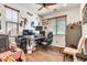 Spacious office space features custom decor, wooden floors and trim, and a ceiling fan at 21667 S 225Th Way, Queen Creek, AZ 85142