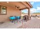 Covered patio features brick pavers and ceiling fan, perfect for enjoying the outdoors at 21667 S 225Th Way, Queen Creek, AZ 85142