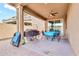 Covered patio with ceiling fan and brick pavers, perfect for outdoor entertaining at 21667 S 225Th Way, Queen Creek, AZ 85142