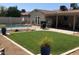 A backyard with a pool, lawn, and patio area great for outdoor gatherings and relaxation at 2210 W Tonto Ln, Phoenix, AZ 85027