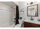 Charming bathroom featuring shower/tub combo, a vanity, mirror and decorative accents at 2210 W Tonto Ln, Phoenix, AZ 85027