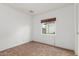 Neutral-toned bedroom provides a minimalist style with a window offering natural light at 2210 W Tonto Ln, Phoenix, AZ 85027