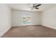 Bright bedroom with a ceiling fan and french doors that open to a private pool at 2210 W Tonto Ln, Phoenix, AZ 85027