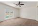 Bedroom featuring a ceiling fan and natural light, complete with neutral carpet flooring at 2210 W Tonto Ln, Phoenix, AZ 85027