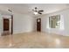 An open room featuring tile floors, neutral walls, and a view into the backyard at 2210 W Tonto Ln, Phoenix, AZ 85027