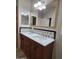 Bathroom boasts a dual sink vanity with decorative backsplash and large mirror at 2233 E Behrend Dr # 203, Phoenix, AZ 85024