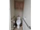 Bathroom featuring toilet with bidet, hand rails and overhead cabinet for storage at 2233 E Behrend Dr # 203, Phoenix, AZ 85024