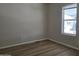 This cozy bedroom features wood-look flooring and a bright window at 2233 E Behrend Dr # 203, Phoenix, AZ 85024