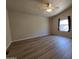 Spacious bedroom with wood floors, a window for natural light, and a ceiling fan for added comfort at 2233 E Behrend Dr # 203, Phoenix, AZ 85024