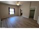 Large bedroom with wood flooring, a ceiling fan, and convenient access to both a closet and the kitchen area at 2233 E Behrend Dr # 203, Phoenix, AZ 85024