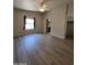 Bright, spacious bedroom featuring wood floors, a window with curtains, and easy access to closet and kitchen at 2233 E Behrend Dr # 203, Phoenix, AZ 85024