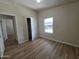 This bedroom features wood-look flooring, bright windows and an open closet at 2233 E Behrend Dr # 203, Phoenix, AZ 85024