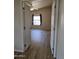 Bright and spacious bedroom featuring wood floors, two entry doors, a window, and a ceiling fan at 2233 E Behrend Dr # 203, Phoenix, AZ 85024