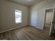 This bedroom features wood-look flooring, bright windows and an open doorway at 2233 E Behrend Dr # 203, Phoenix, AZ 85024