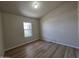 This cozy bedroom features wood-look flooring and a bright window at 2233 E Behrend Dr # 203, Phoenix, AZ 85024