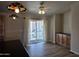 The dining area features wood floors, a ceiling fan, beautiful pendant lighting, and sliding door access to the outside at 2233 E Behrend Dr # 203, Phoenix, AZ 85024
